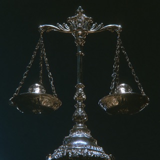A silver balance scale, level, on black. Coherent Breathing in Pulmonaut.